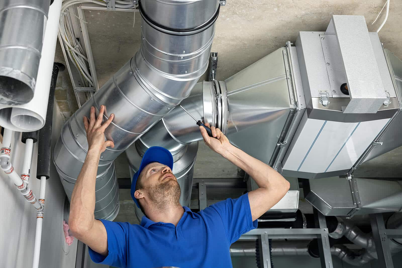HVAC technician inspecting and repairing air ducts in South San Francisco