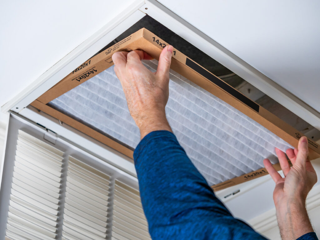 HVAC technician replacing a home air filter in South San Francisco