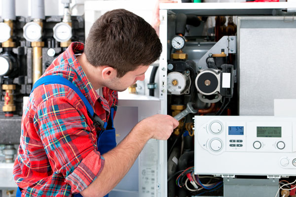 Heating technician repairing boiler controls in South San Francisco