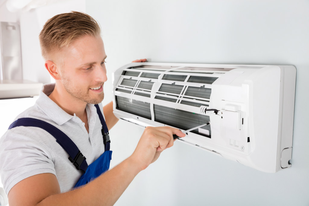 HVAC technician maintaining a ductless air conditioner in South San Francisco