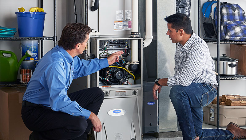 Technician evaluating a furnace for repair or replacement in South San Francisco