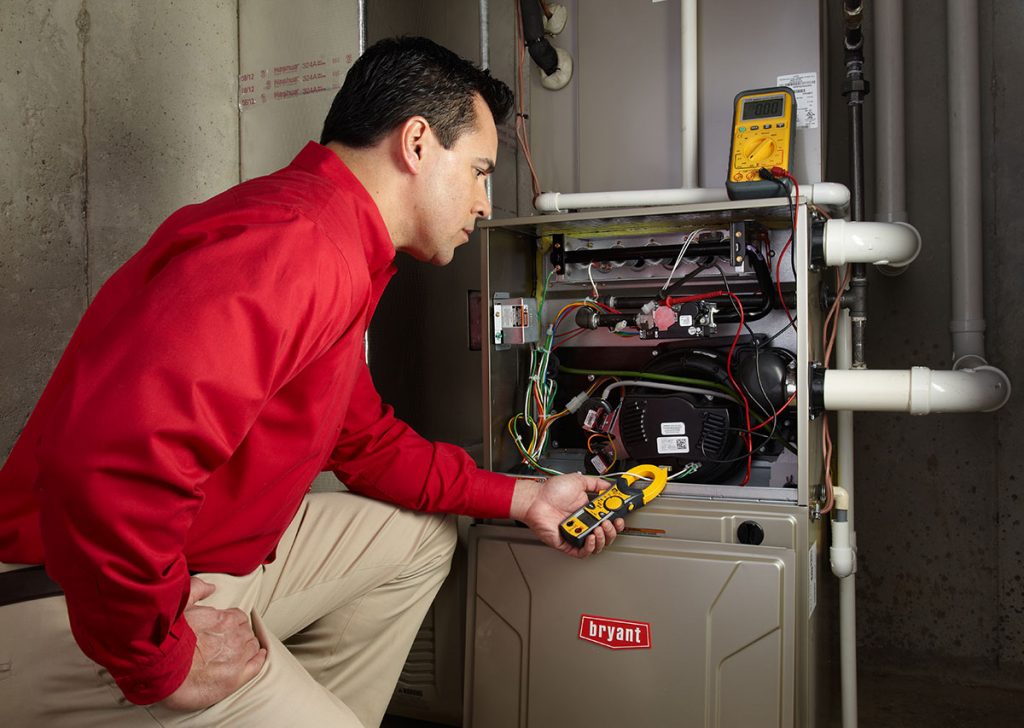 Heating technician diagnosing a furnace repair in South San Francisco