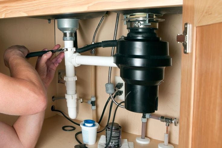 Plumber repairing a garbage disposal in South San Francisco