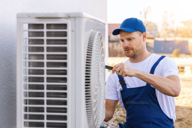 HVAC technician servicing an outdoor air conditioner in South San Francisco