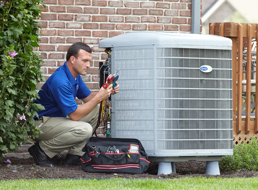 HVAC technician inspecting an outdoor AC unit in South San Francisco